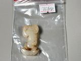 a small teddy bear in a plastic bag on a table