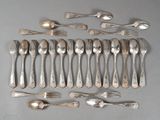 a lot of spoons and forks laid out on the table