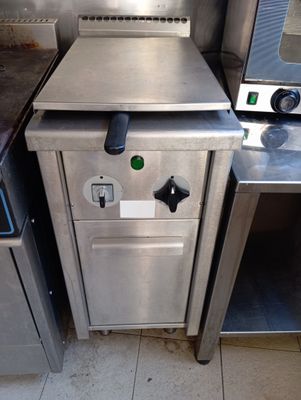 stainless steel counter top with a stove and oven in a commercial kitchen