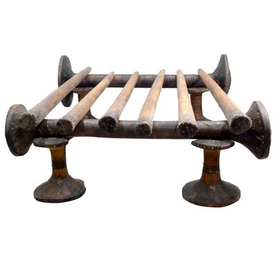 a metal bed with wooden slats on top of it