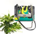 a small purse with a chain hanging from it
