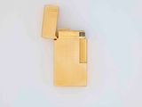 gold plated lighter on a white surface with a lighter in the middle