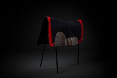 a black and red chair with a blanket on top of it