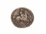 une image représentant une pièce de monnaie sur laquelle figurent un cheval et un cavalier
