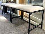 a bench with a cushion on top of it in a room