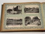 an open book with pictures of a town and a clock tower