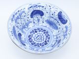 a blue and white bowl with flowers on it