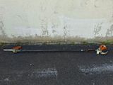 two lawn mowers laying on the ground next to a wall