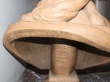 a statue of a woman holding a baby on top of a table