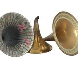 two old fashioned brass musical instruments sitting next to each other
