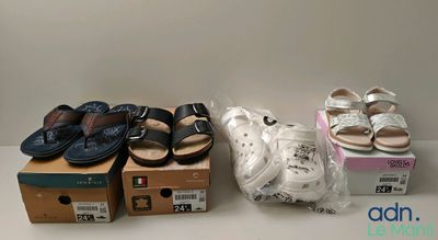 many pairs of shoes that are sitting on a table