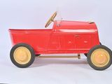a red toy car with a steering on a white background