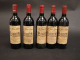 quatre bouteilles de vin sont alignées sur une table