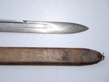 two knives that are laying next to each other on a table