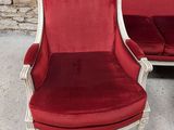 pair of red and white chairs in front of a stone wall