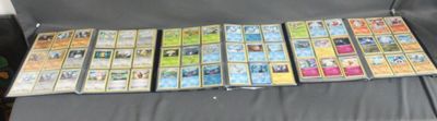 a lot of pokemon trading cards on the couch