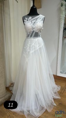a dress on a mannequin stand in front of a mirror