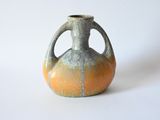 a small vase that is sitting on a white surface