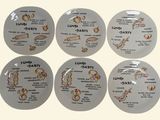 six plates with different types of food on them on a white surface