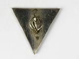 triangle shaped metal object with a man on it on a white surface