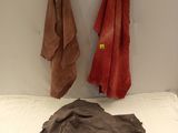 two towels hanging on the wall next to a bed