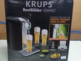 packaging of a beer machine sitting on top of a white table