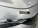 a close up of a car ' s headlight with a sticker on it