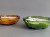 two bowls that have candles in them on a table