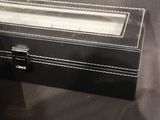 a small black box with a glass lid on a table