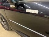 a car that has a sticker on the side of it ' s door