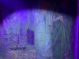a blurry image of a person in a purple light
