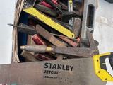 a box full of tools and a saw on a table