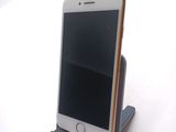a cell phone that is sitting on top of a stand