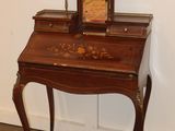 a small desk with a clock on top of it