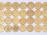 some gold coins are arranged on a white surface