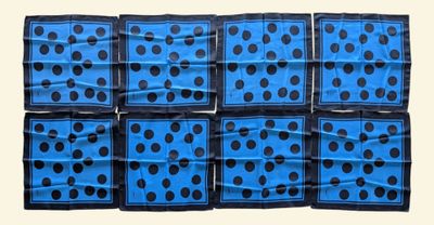 six blue and black polka dot napkins stacked on top of each other