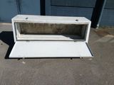 a white microwave oven sitting on the ground outside