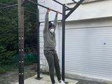 a man that is doing a pull up on a pull up bar
