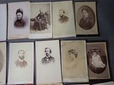 several old black and white photographs of men and women sitting on a table