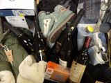a pile of wine bottles and other items in a box