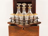 a wooden box with a set of wine glasses in it