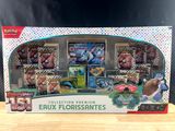the box contains a collection of pokemon trading cards and collectibles