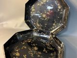 an image of a black and gold octagonal shaped box on a white background