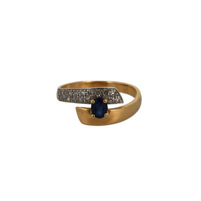a close up of a gold ring with a blue stone