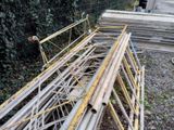 a pile of construction materials on the ground next to a fence