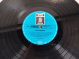 a black record with a blue label on it
