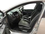 the interior of a car with the door open and the driver ' s seat down