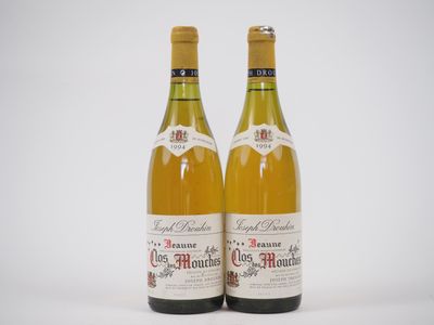 deux bouteilles de vin posées l'une à côté de l'autre sur une surface blanche
