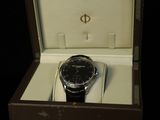 a watch in a box on a black surface