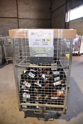 a metal cage filled with bottles of wine in a warehouse
